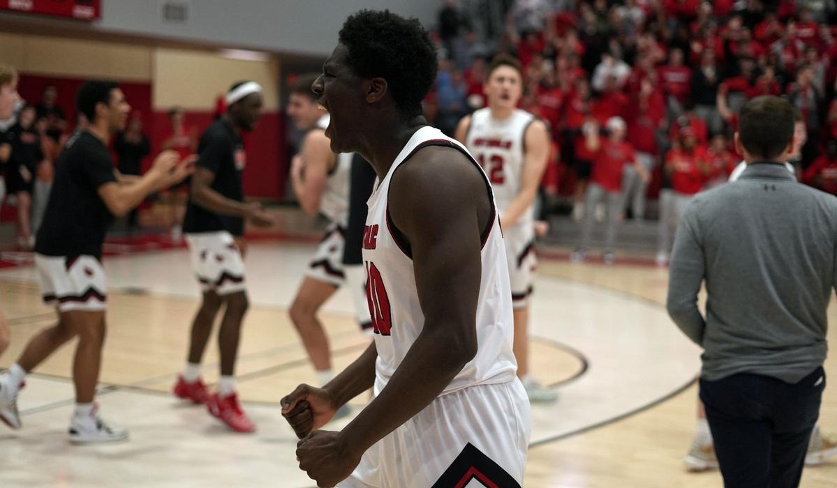 CUA basketball player celebrating during a game