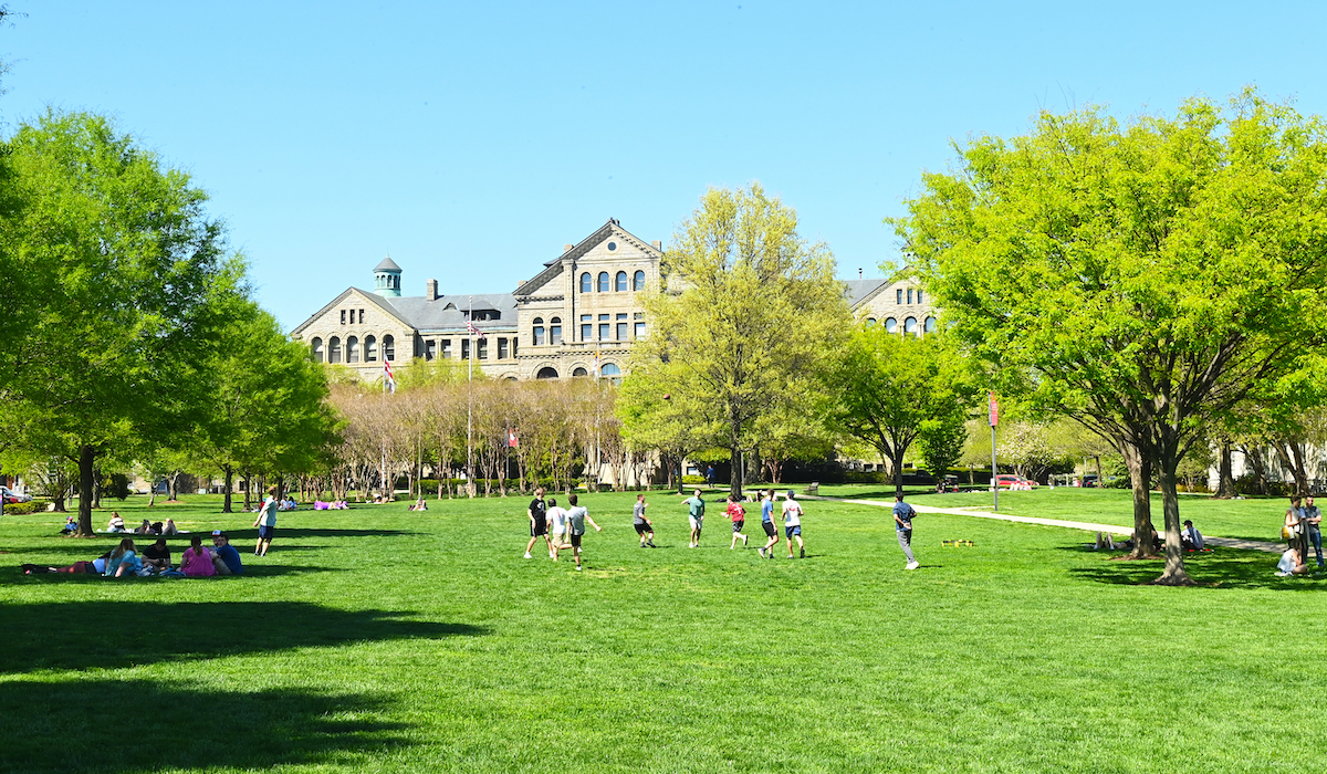Students playing on a campus lawn