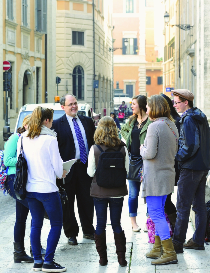 Center Director David Dawson Vasquez and students in his Liturgical Art and Architecture course outside the Basilica of St. Ignatius Loyola. The church’s interior vault by Andrea Pozzo and imposing façade are pictured above.