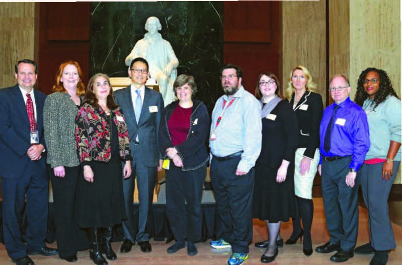 Alumni who work at the Library of Congress (from left) Mark Sweeney, Marybeth Wise, Abby Yochelson, David Mao, Susan Reyburn, Peter Goodman, Nicole Marcou, Adrija Henley, Tim Carlton, and Heather Wiggins are seen in Madison Hall during an October alumni event hosted by the Department of Library and Information Science.