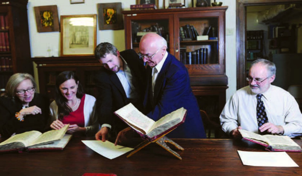Members of the Christian Communities of the Middle East Cultural Heritage Project Team, including (from left) Robin Darling Young, Ryann Craig, Andrew Litke, Shawqi Talia, and Kevin Gunn, examine manuscripts from the University's Institute of Christian Oriental Research. Not pictured: Sam Russell, graduate student research assistant, and Clifford Patterson, web developer and designer.