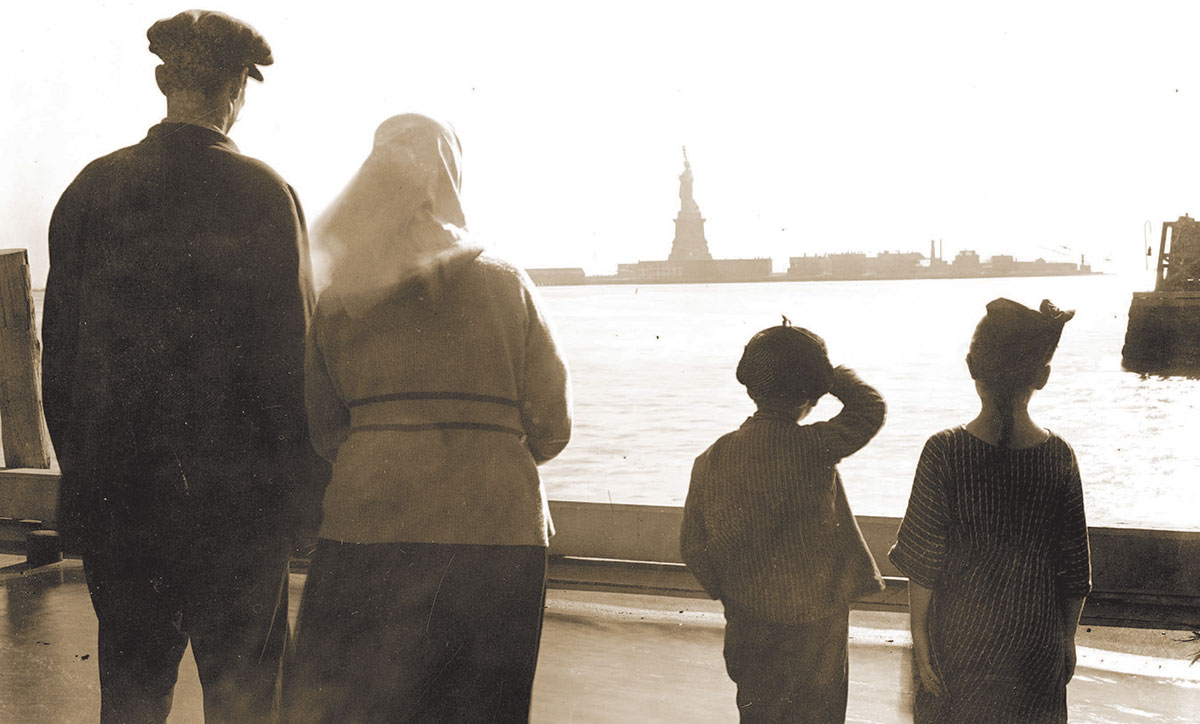 Immigrant family looking at Statue of Liberty