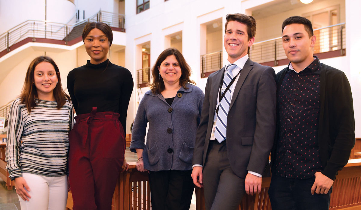 Law Professor Stacy Brustin directs the Immigrant and Refugee Advocacy Clinic. She is pictured, center, with students Maria Lino Callao, Kelechi Eke, Daniel Enos, and Alex Catiggay.