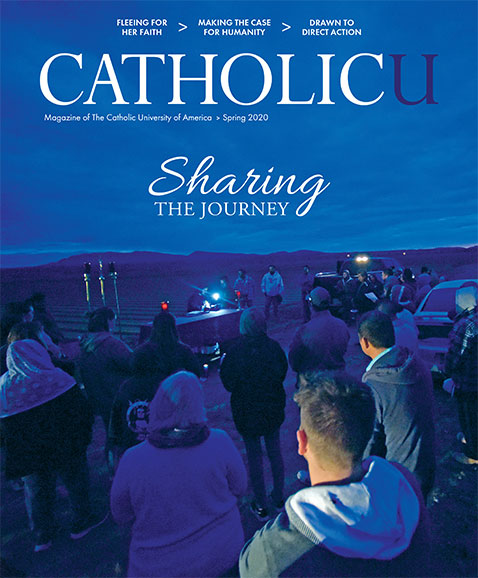 Cover of CatholicU Magazine showing a sunrise Mass in the desert