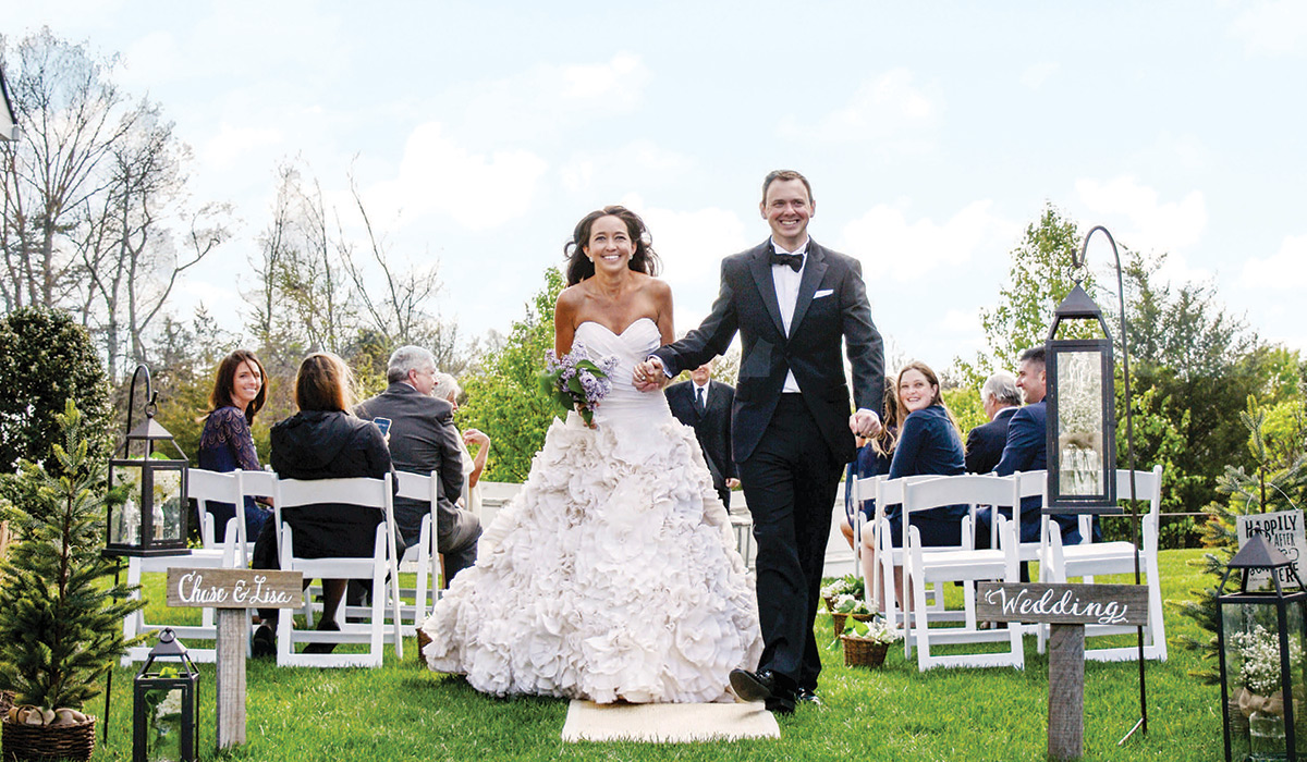 Lisa Kovacic and Chase McAlpine walk down the aisle at their outdoor wedding