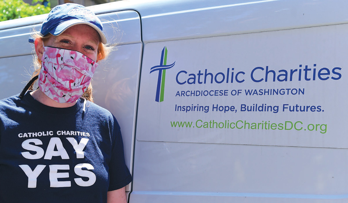 Bridget Maley wearing a mask and Catholic Charities t-shirt