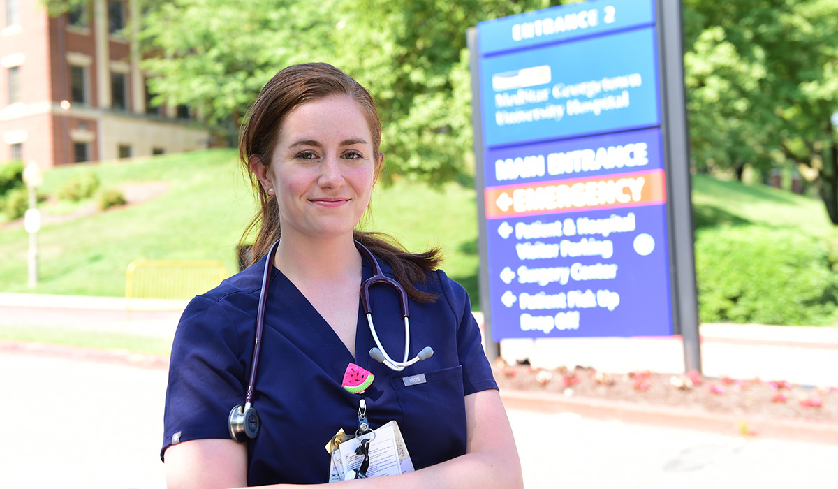Nurse Morgan Gluck stands outside the hospital where she works. 