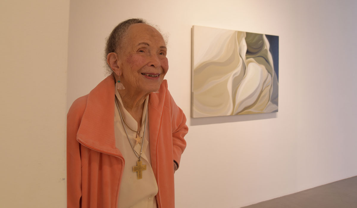 Lilian T. Burwell with painting Arctic Flow in background