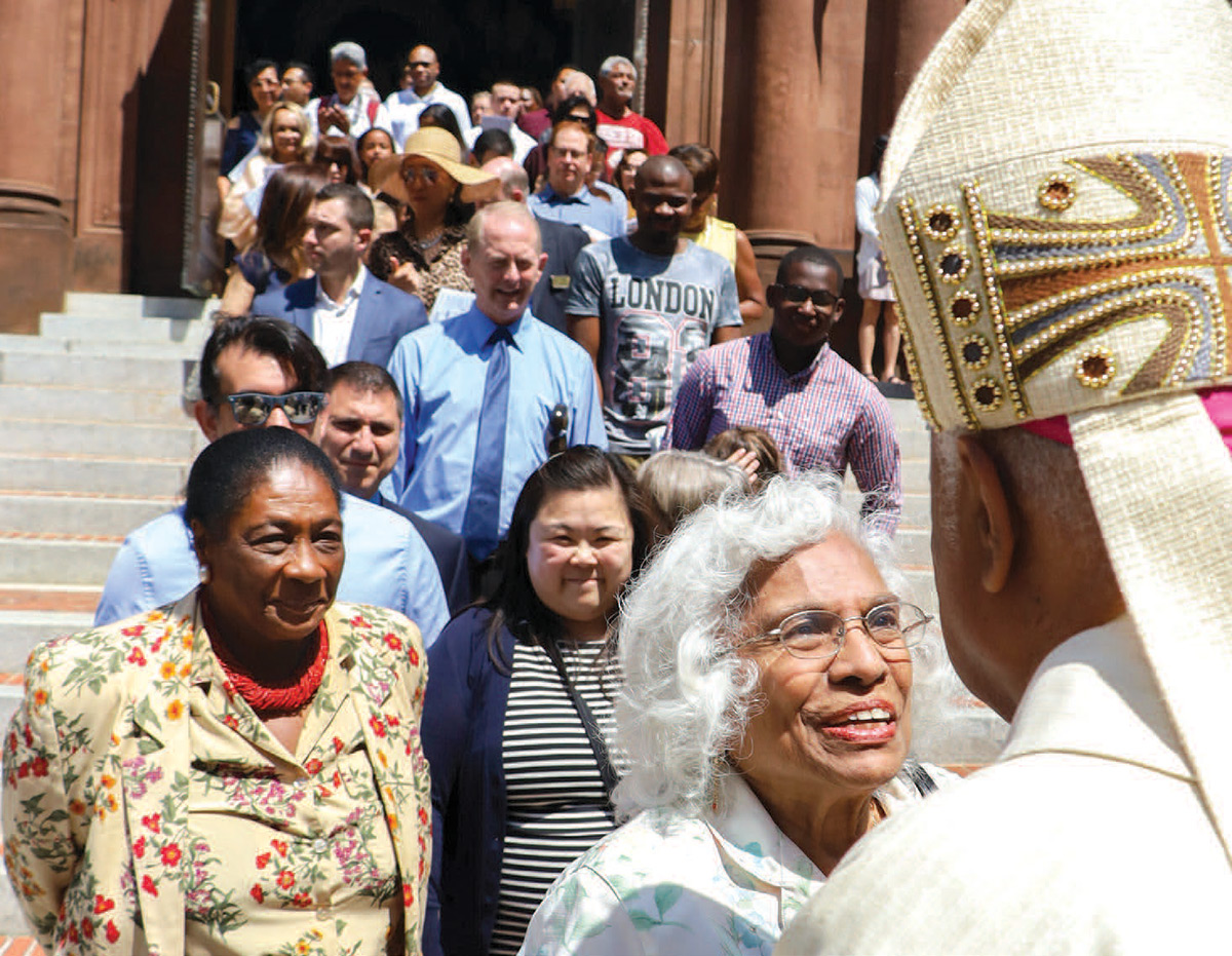 Archbishop Wilton Gregory greets parishioners outside the Cathedral of St. Matthew the Apostle in May 2019.