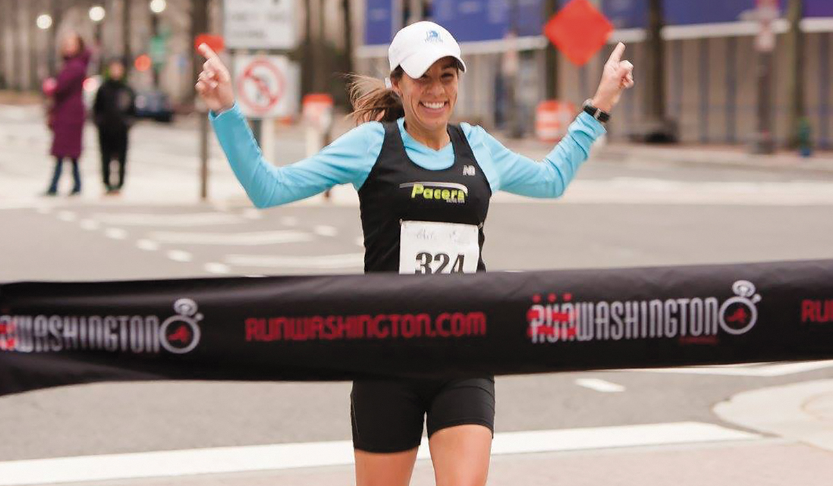 Vanessa Corcoran crossing the finish line at a race