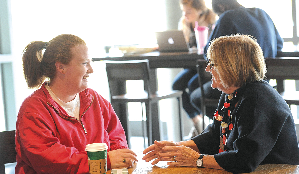 Jeanne Garvey chats with a student over coffee