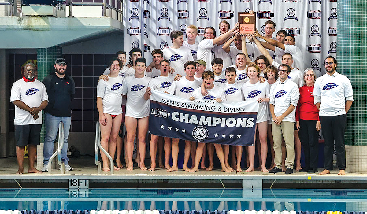 men's swim and dive team poses with its championship poster