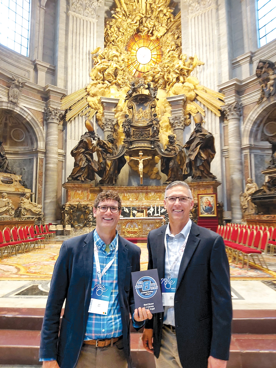 Max Engel and Matt Hoven smile with their book at St. Peter's Basilica