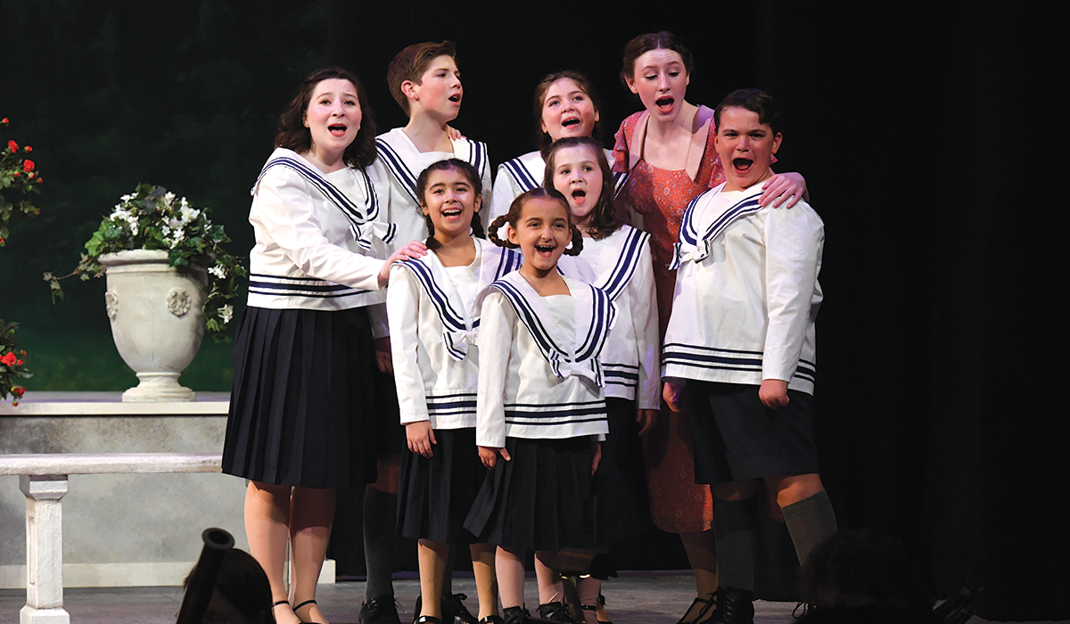 the cast of Sound of Music singing during a performance