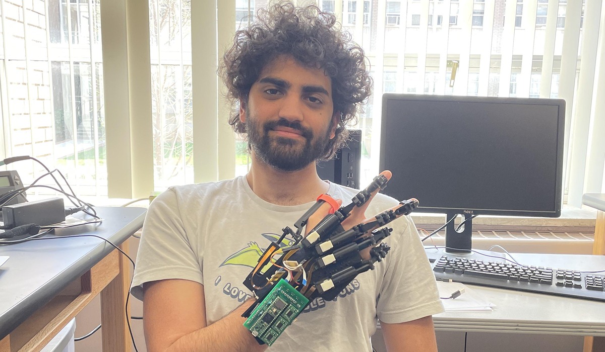 Biomedical engineering doctoral candidate Matteo Pergami-Peries poses with his design for a motorized exoskeleton for physical therapy for stroke survivors