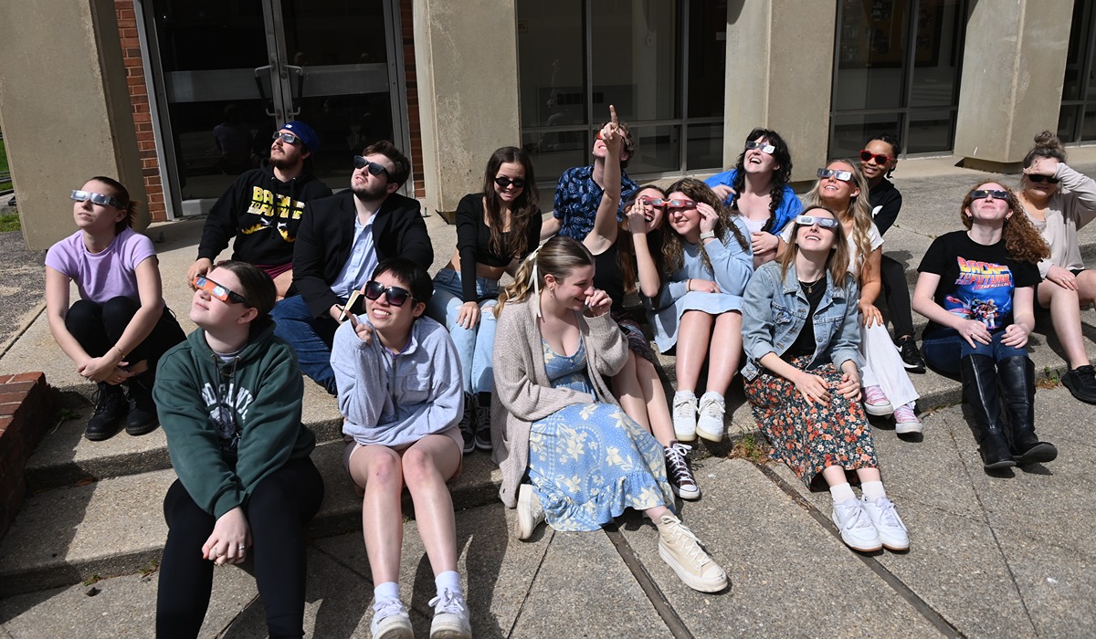 The eclipse was such a showstopper that Drama Associate Professor Rosalind Flynn held her class outdoors at Hartke Theatre’s courtyard. (Catholic University/Patrick G. Ryan) 