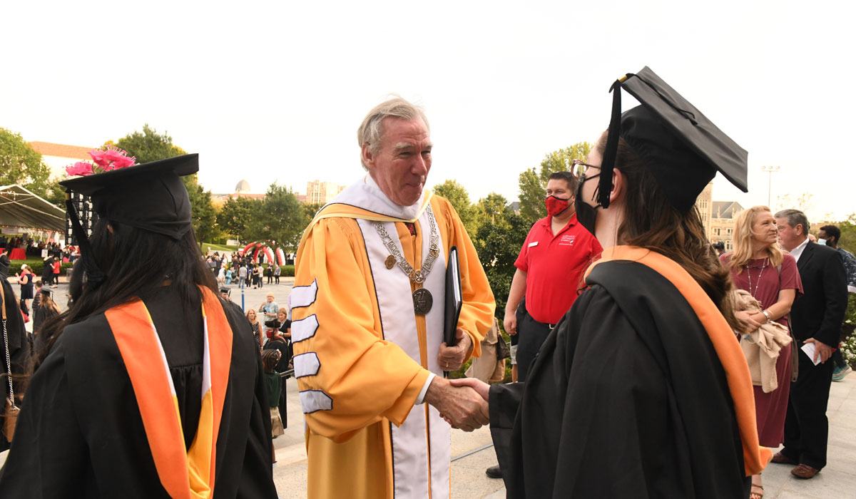 President Garvey shaking hands with students