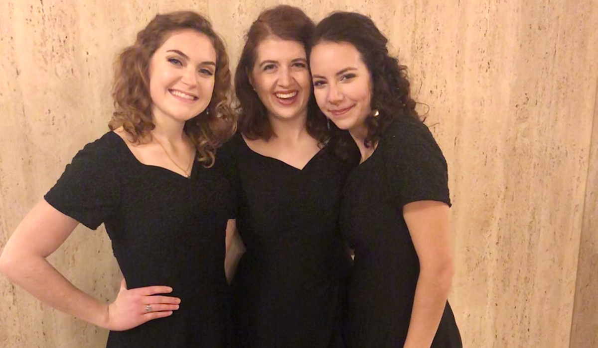 Three female members of the University Singers at the Annual Christmas Concert for Charity