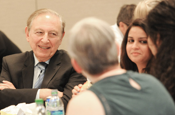 Robert Gallo talks with students and faculty at biology research symposium.