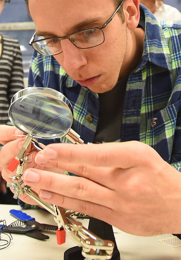 Student using magnifying glass for close work