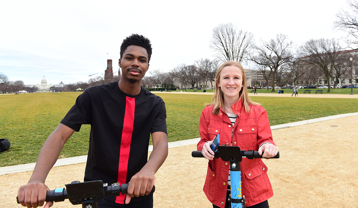 Students riding scooters on the National Mall 