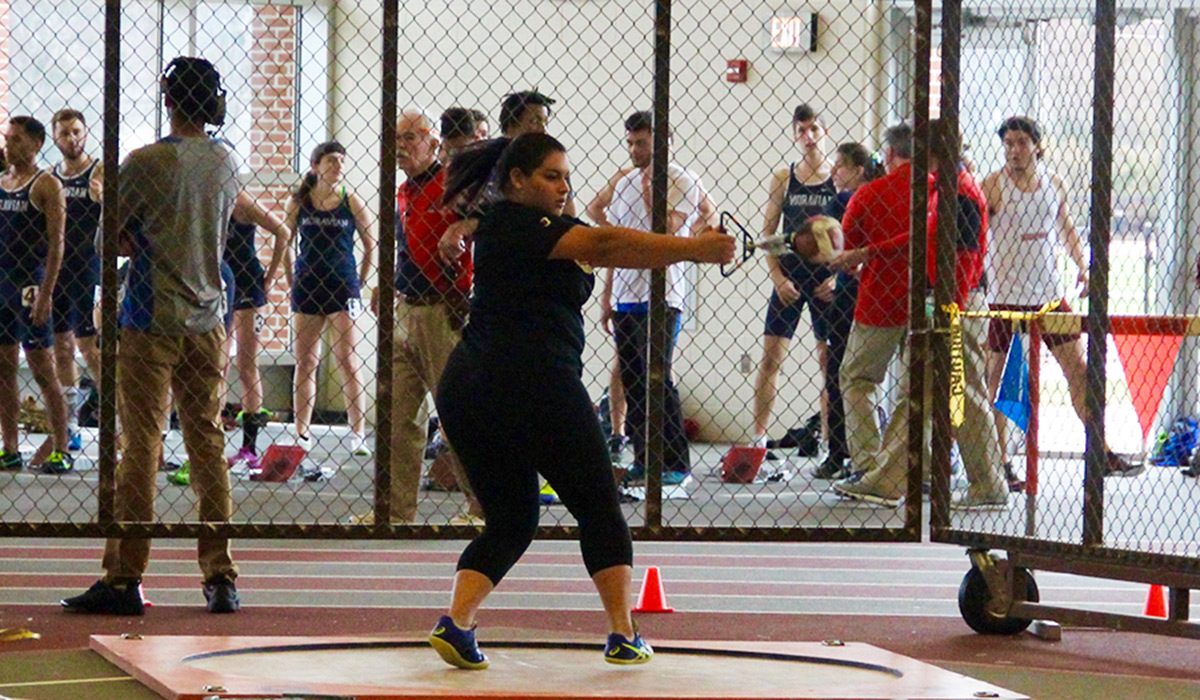 Female athlete competing in throwing event for track and field
