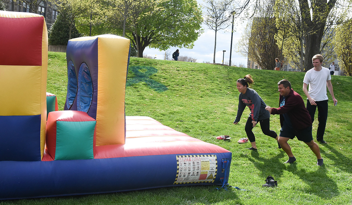 Student running an inflatable obstacle course