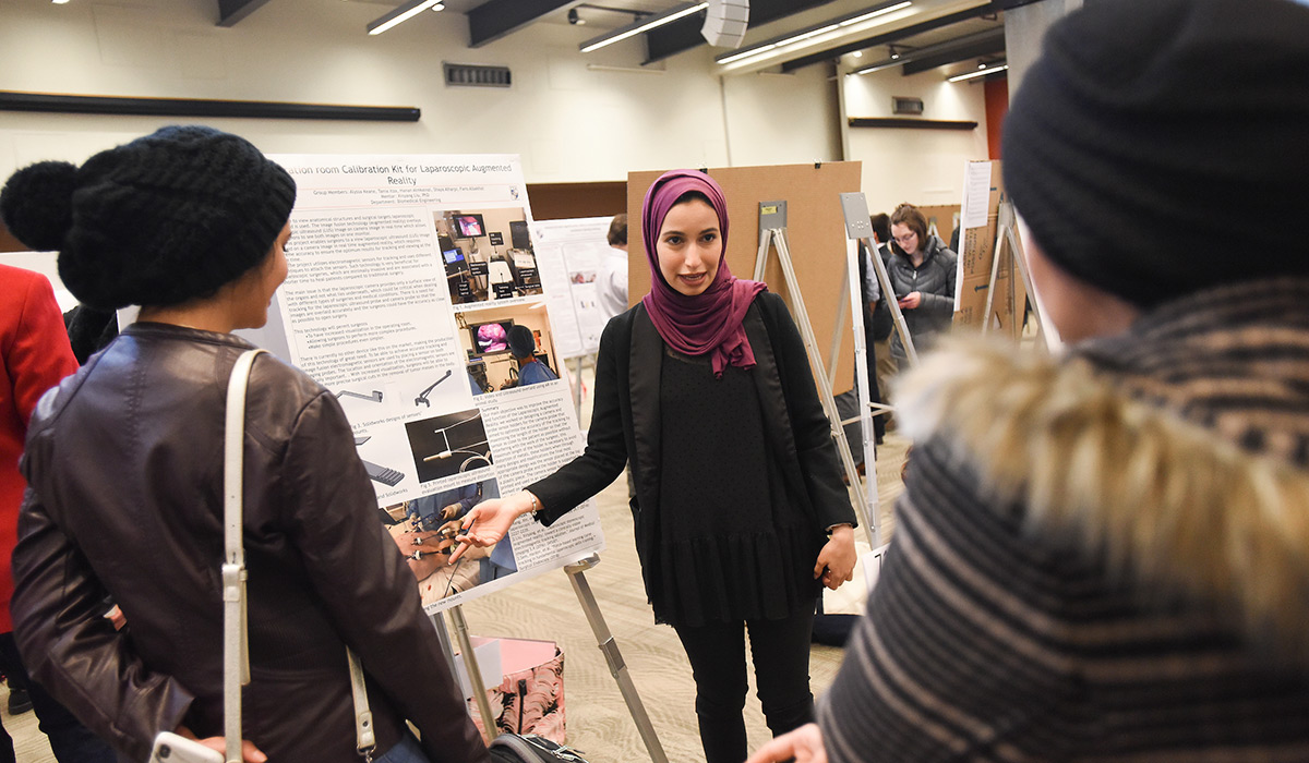 Student presenting a poster 