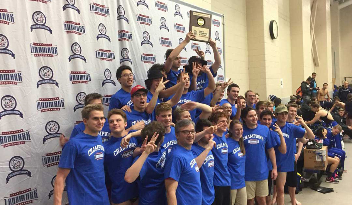 Men's swimming team photo with trophy