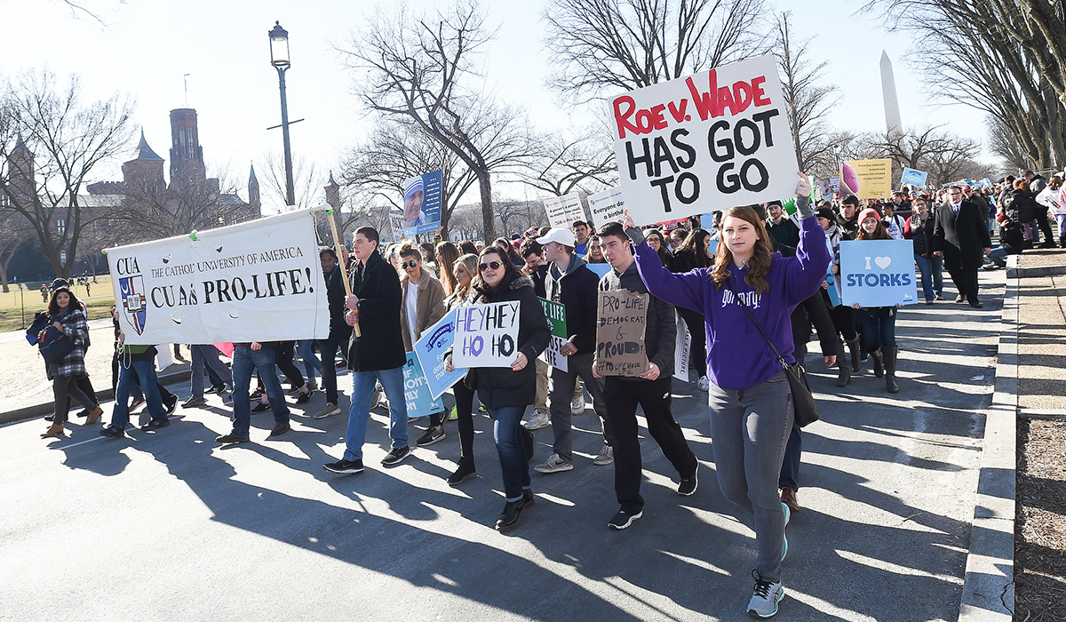 Students holding signs and marching