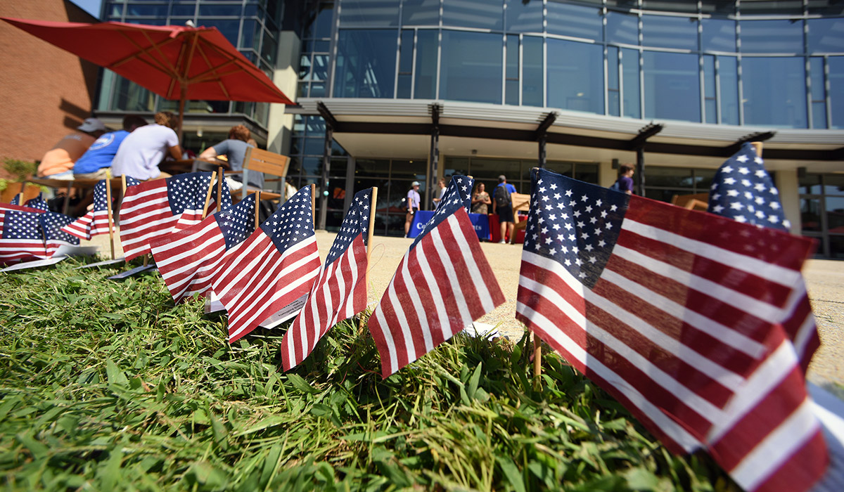 A line of American flags placed in front the the pryz