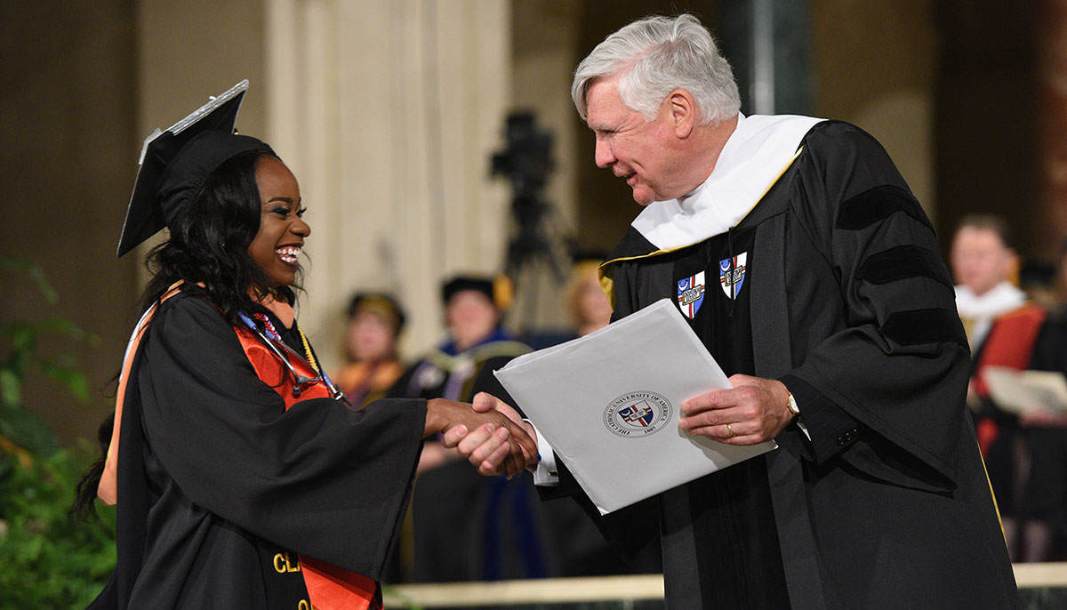 Bill Conway congratulates Scholastica Ibezimako, a Conway Scholar, on completing her nursing education at the 2017 graduation ceremony. 
