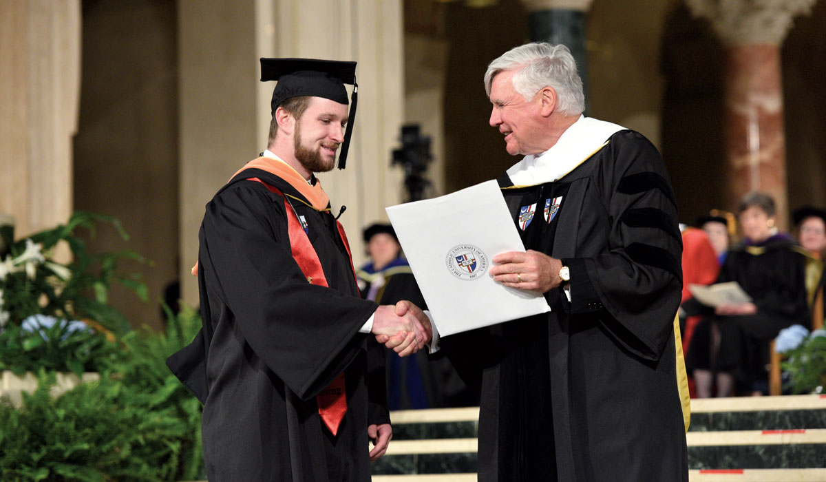 Conway Scholar Greg Daly receives his diploma from Bill Conway at his 2017 graduation.