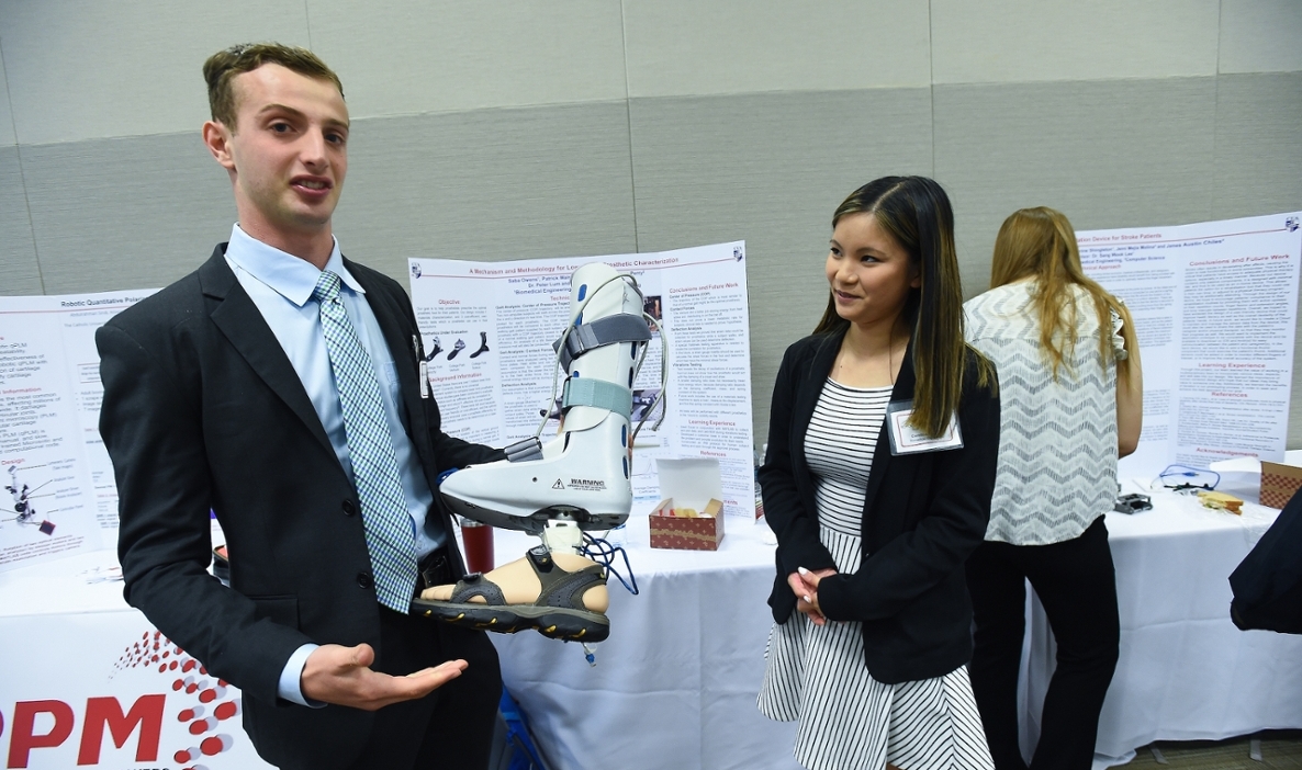 Engineering students showing prosthetic leg the developed