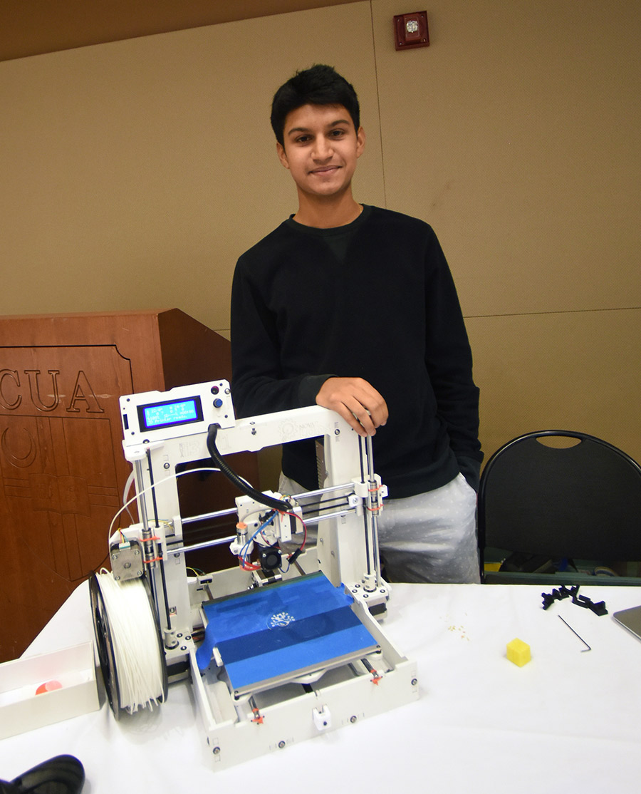 Student standing next to 3D Printer