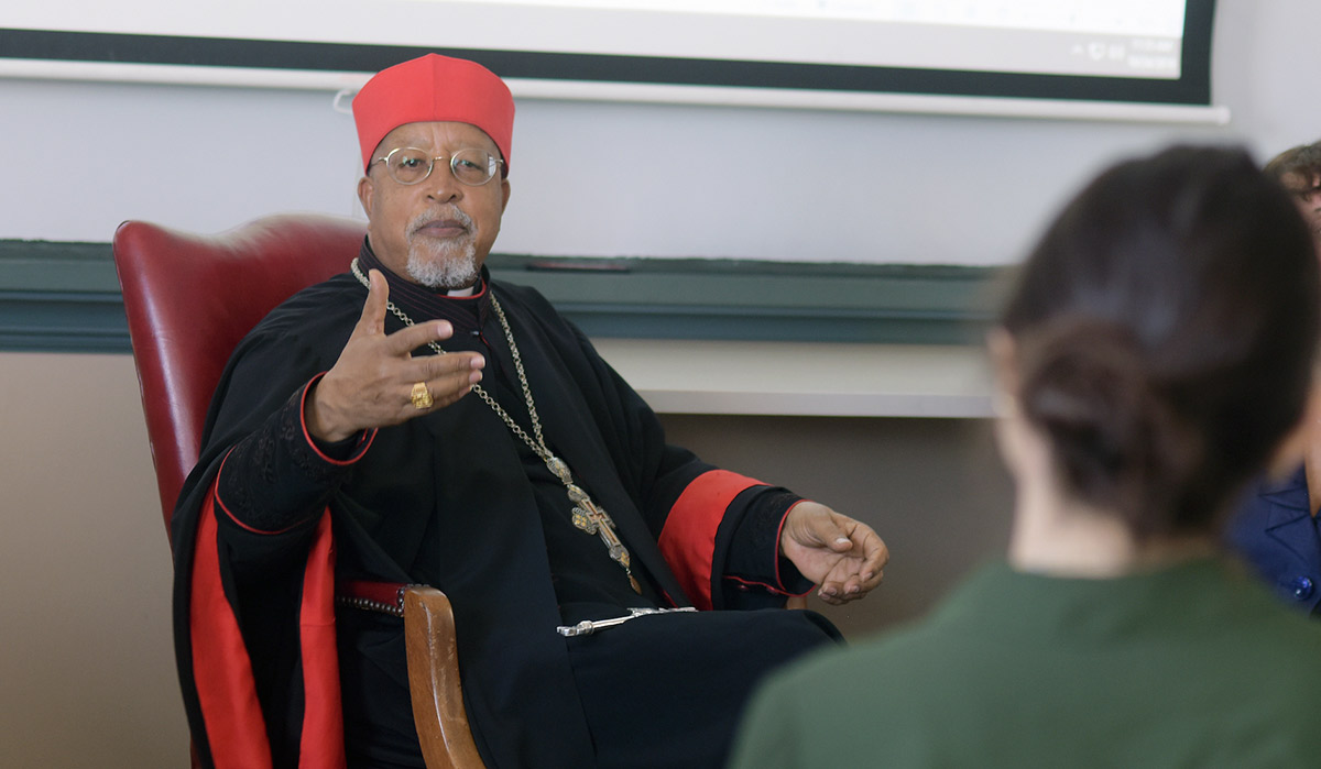 Cardinal speaking to class