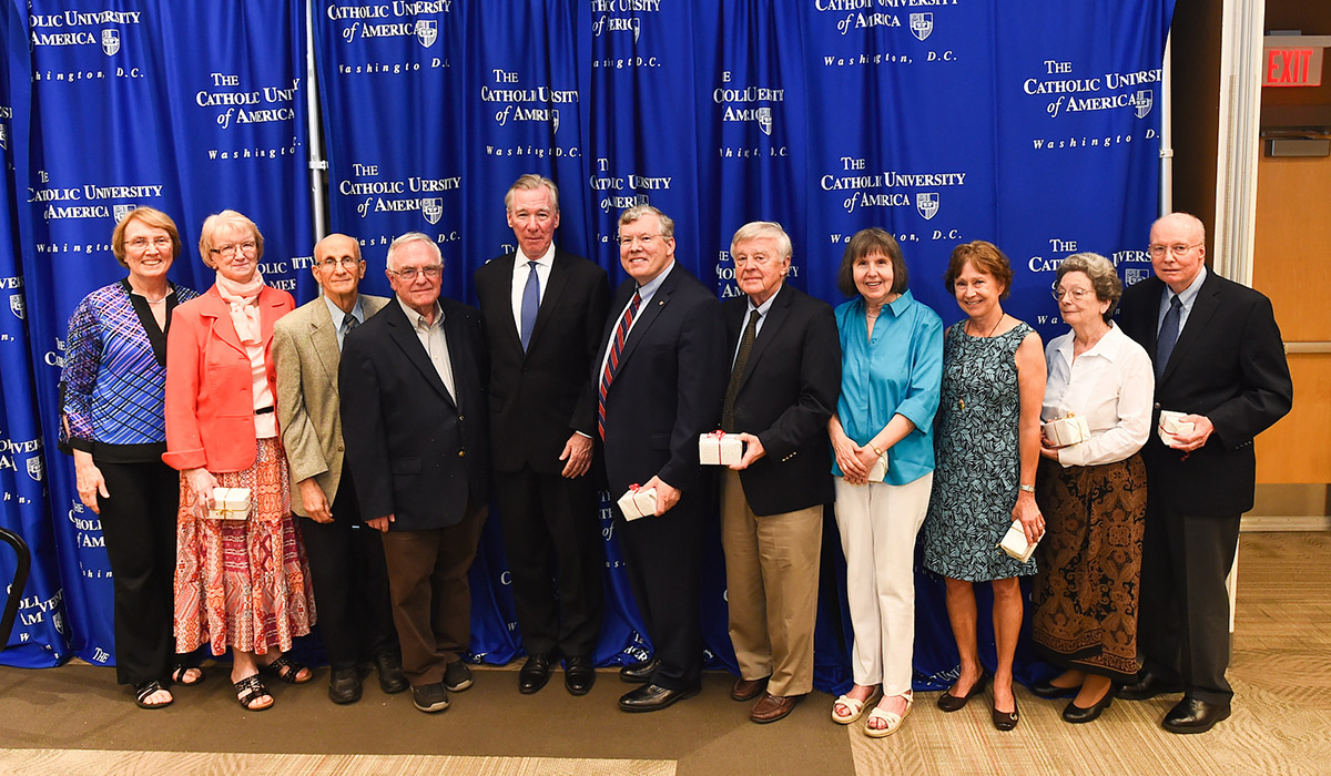 Faculty award recipients standing with President Garvey