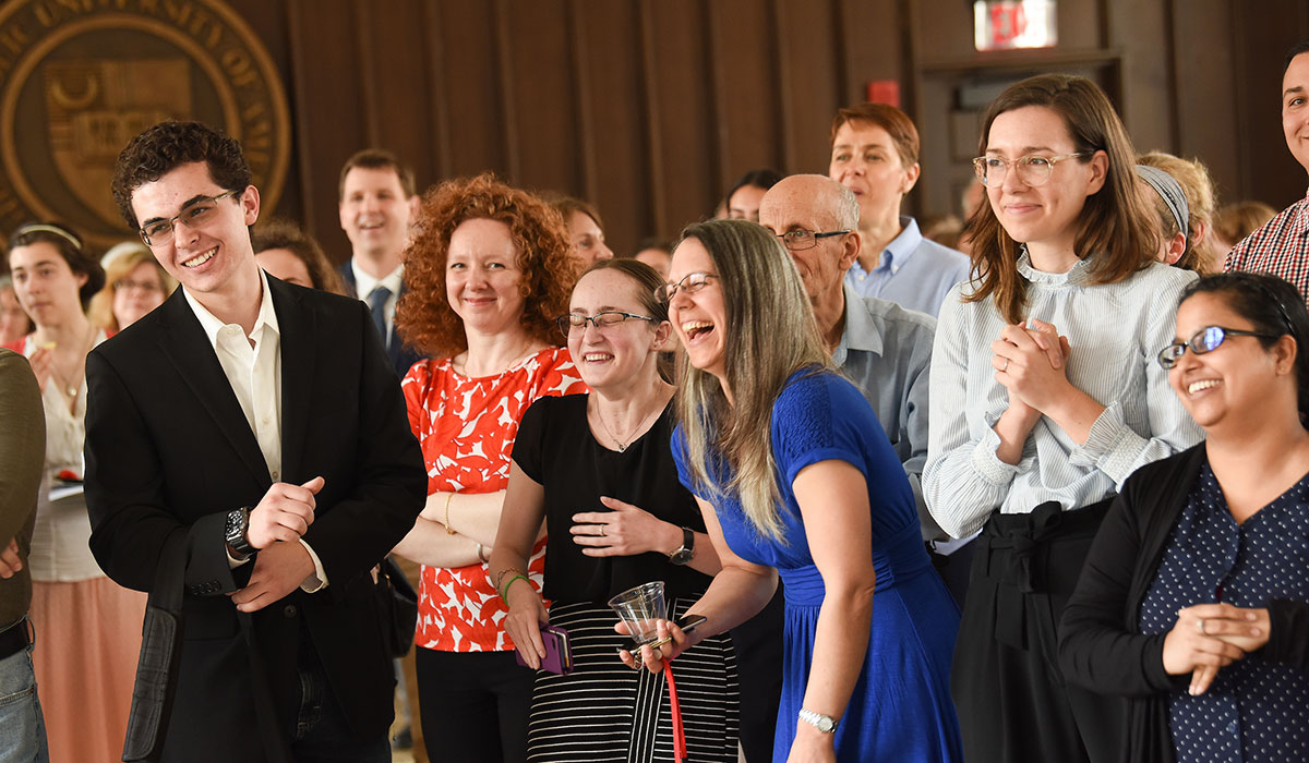 Students and professors laughing at awards ceremony