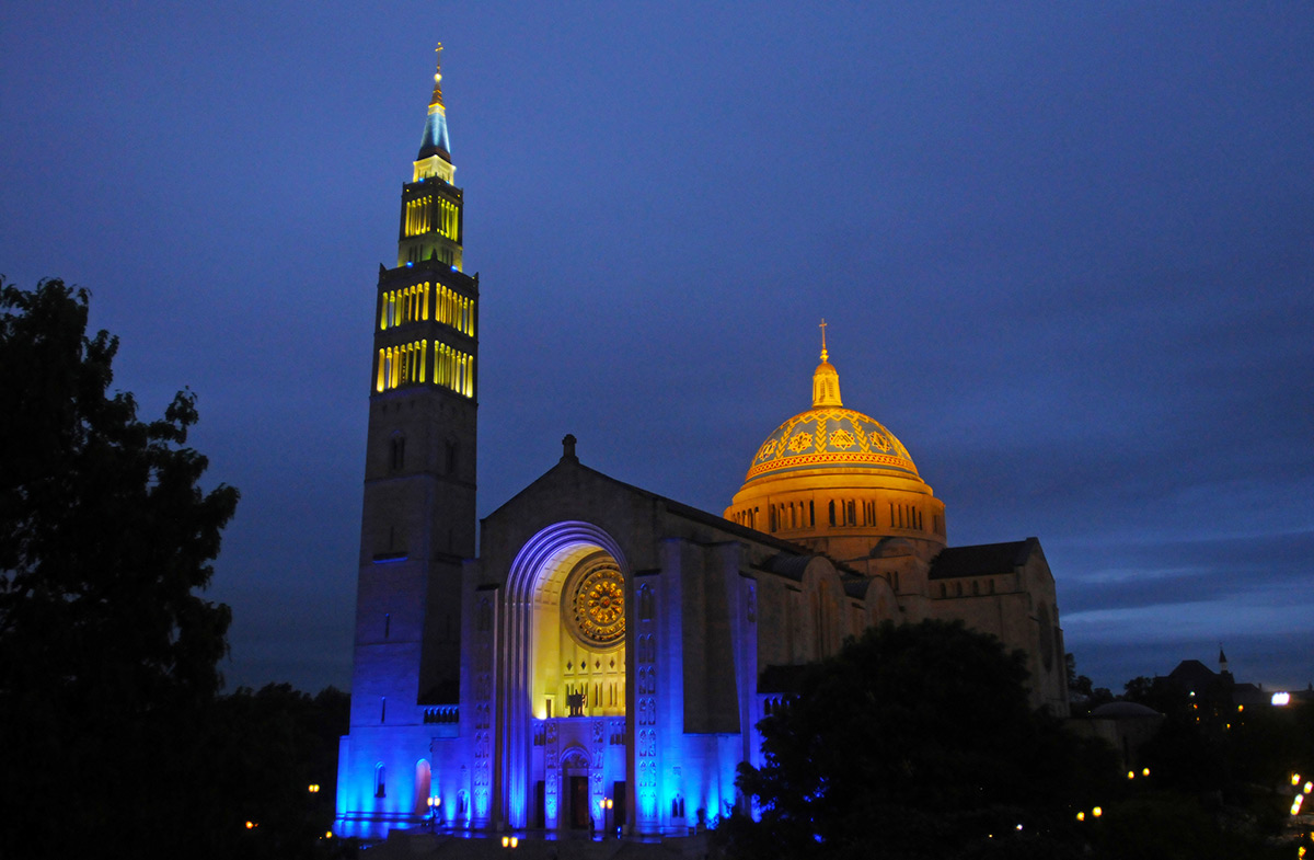 Basilica of the National Shrine of the Immaculate Conception lit up with blue lights
