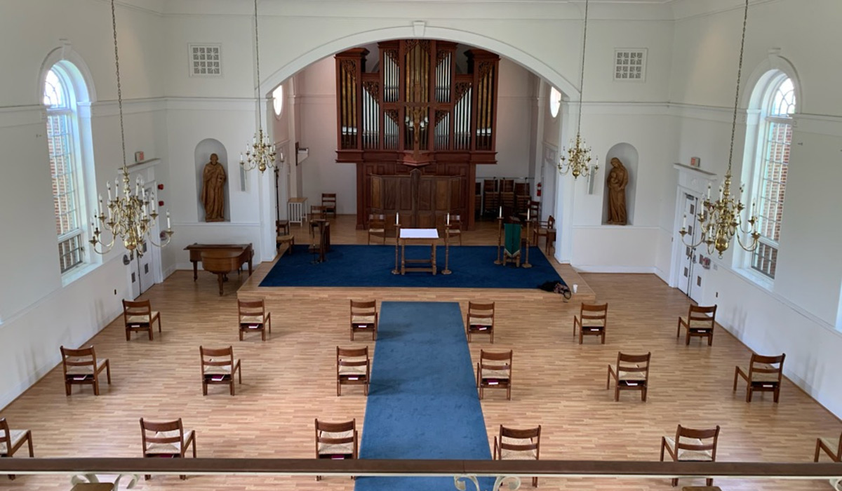 Chairs set six feet apart in chapel