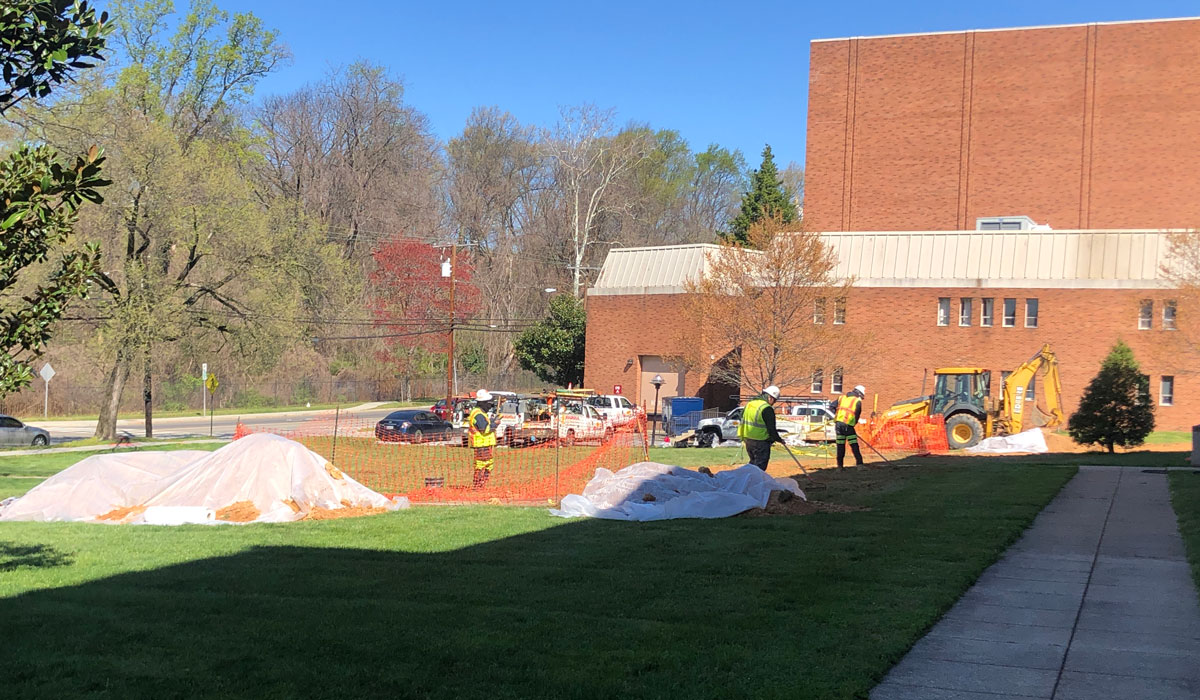 Workers installing water line outside Leahy Hall