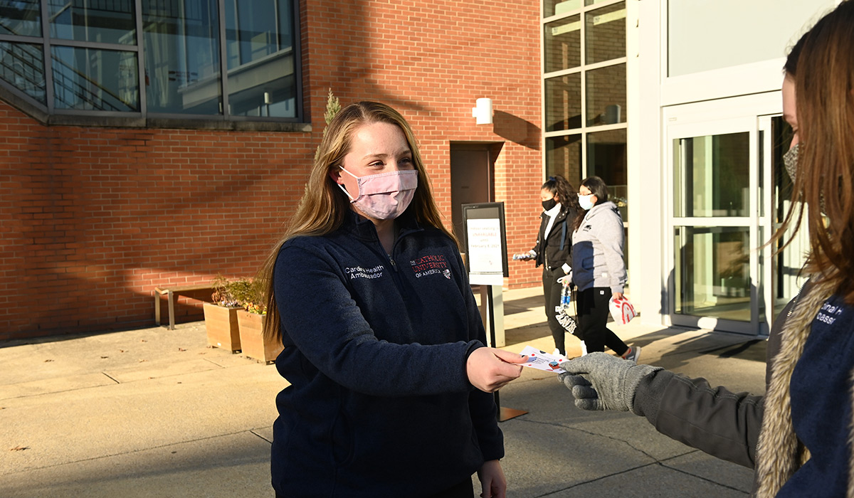 Cardinal Health Ambassador Marie Fitzpatrick hands out raffle tickets to students she encounters who are practicing COVID-19 safety guidelines. 