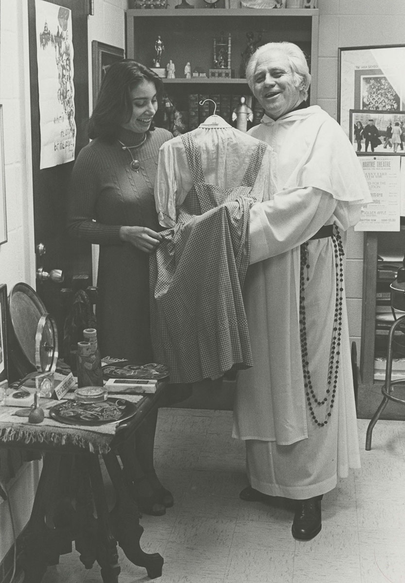 Father Hartke holding Judy Garland dress