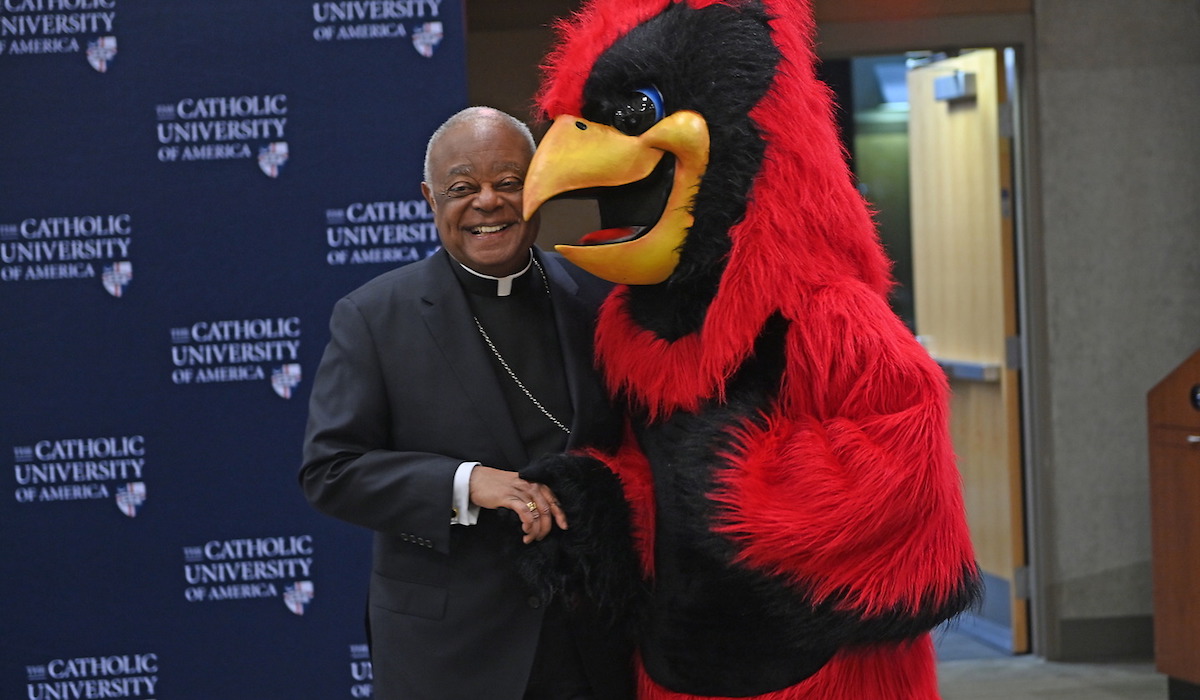 Cardinal Gregory and Red the Cardinal pose for picture together