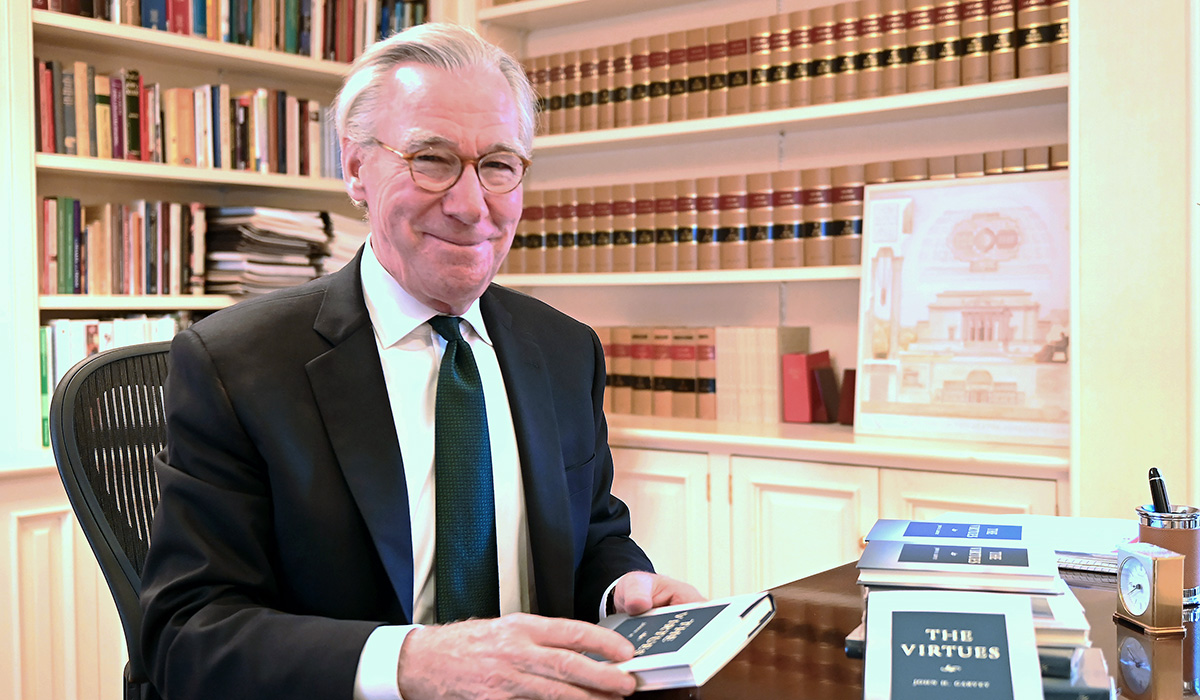 President Garvey at his desk with his new book