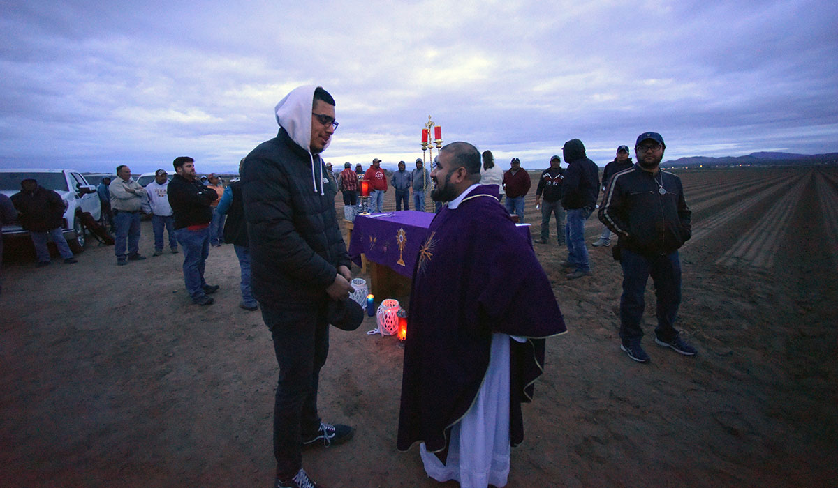 Student talking to priest after sunrise Mass