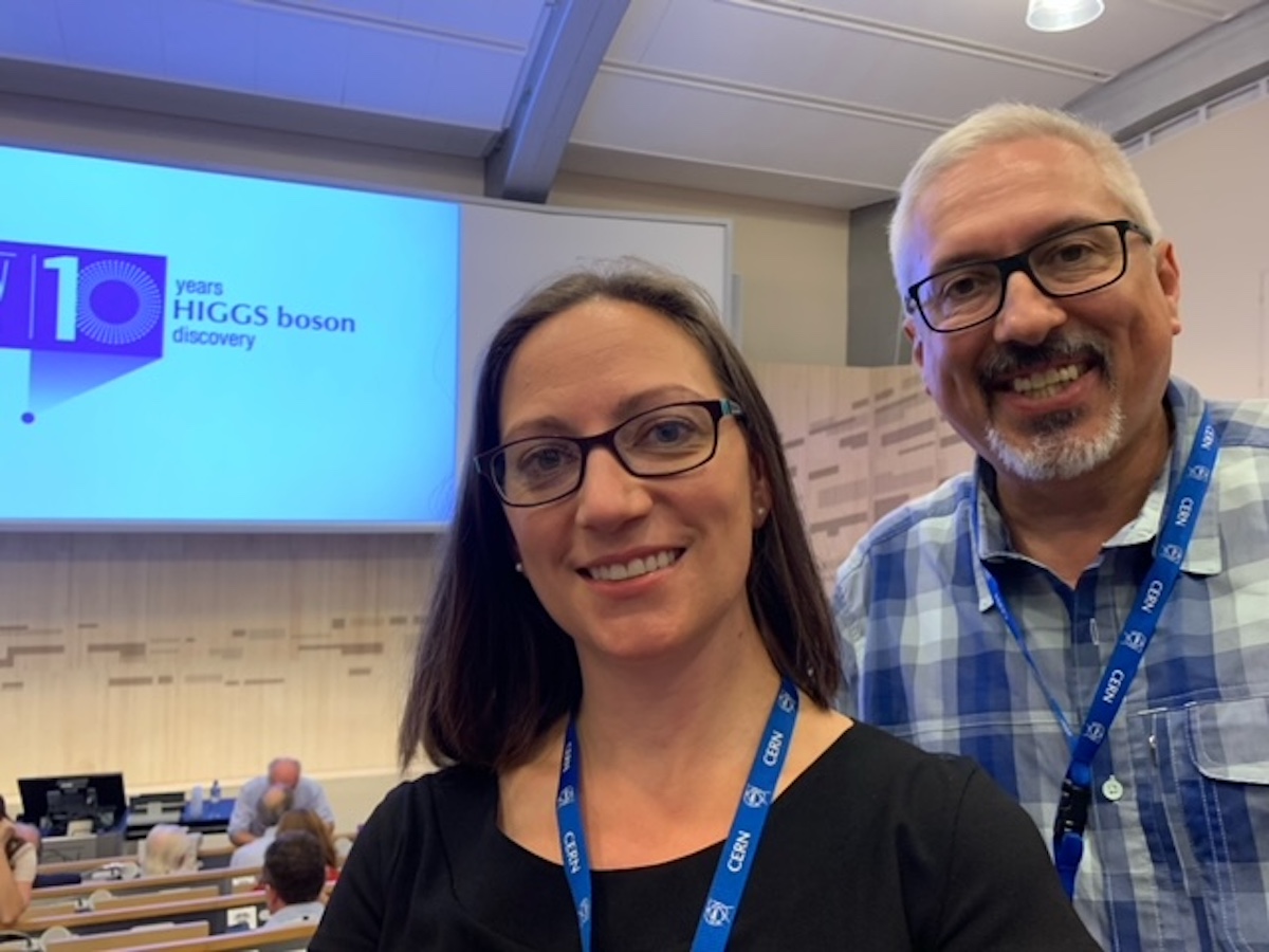 selfie of assistant research professor Rachel Bartek and provost Aaron Dominguez at the Higgs boson 10th anniversary event